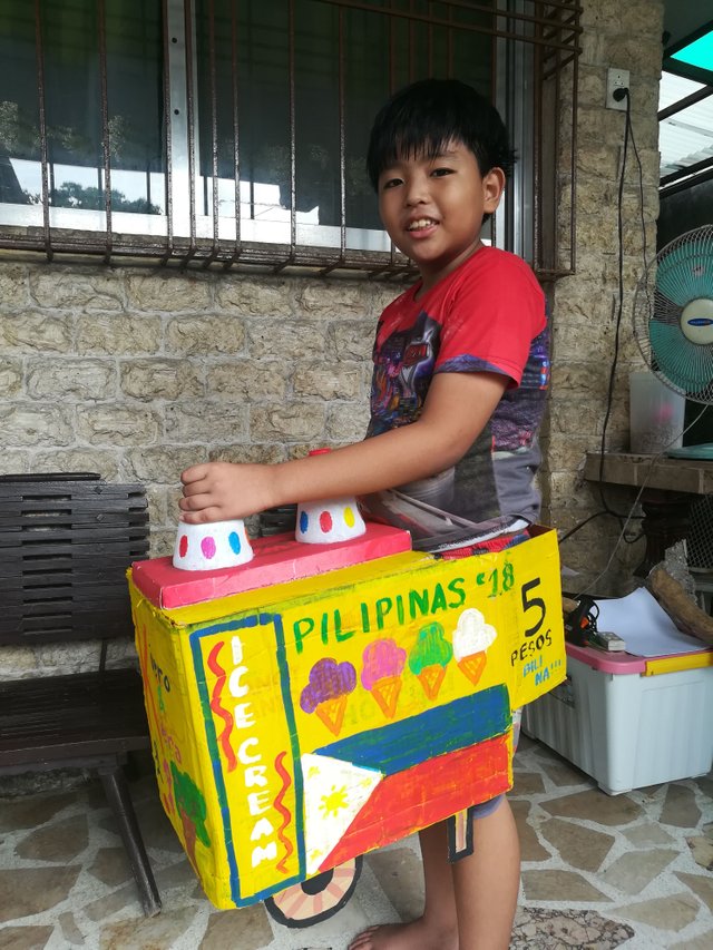 Koko wearing his finished colorful homemade sorbetes cart for Buwan ng Wika