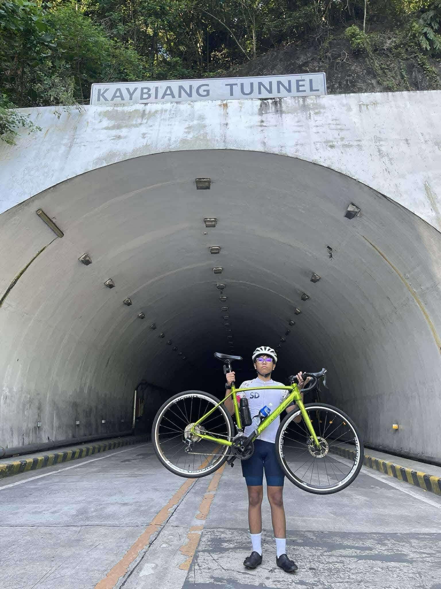 Koko with his bicycle at Kaybiang Tunnel during his 48-kilometer ride with friends