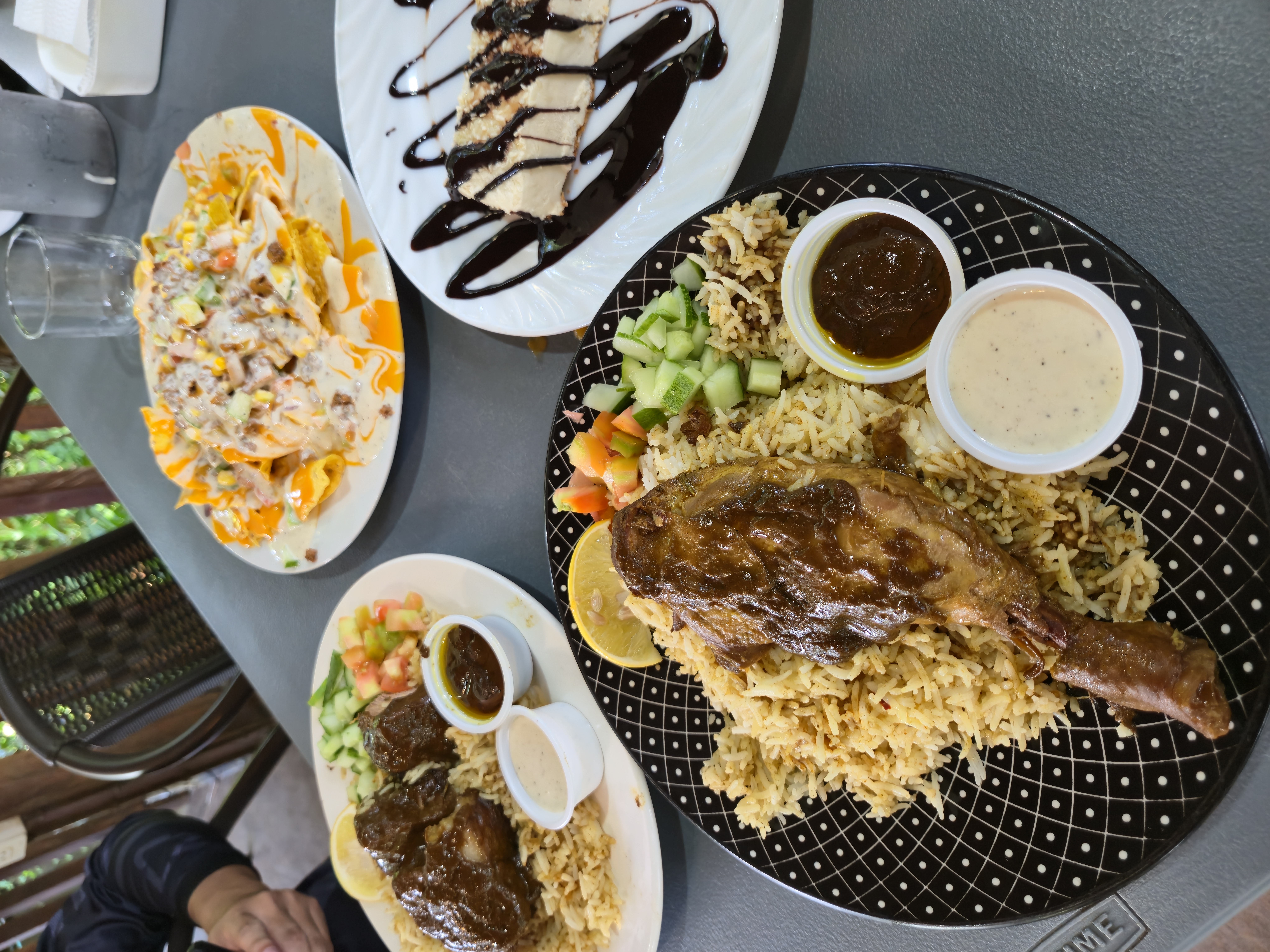 Chicken and beef biryani, nachos, and cheesecake at Tree Top Cafe